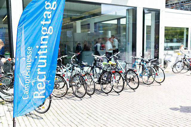 Beachflags of Campus Fair in front of building 3A